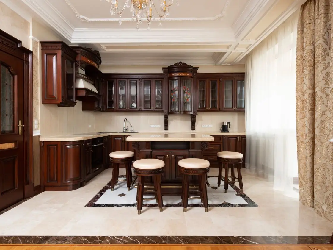 A finished made-to-measure handleless kitchen in a period Surrey home with warm dark cabinetry, aged-brass hardware and a large quartz island